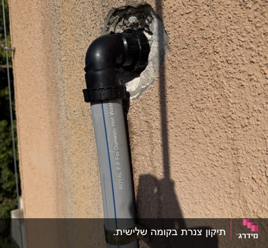 התקנת צינור אינסטלציה חיצוני וחיבור בזווית על קיר בניין